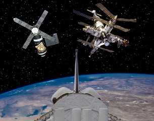 Shuttle goes from earth. Spaceships on the background. The elements of this image furnished by NASA.