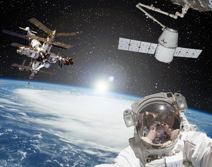 Astronaut, spaceships and sunrise on the backdrop. The elements of this image furnished by NASA.