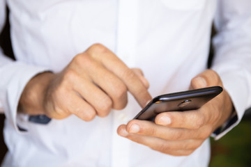 close-up of male hands with a smartphone