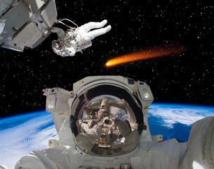 Astronauts and comet. The elements of this image furnished by NASA.