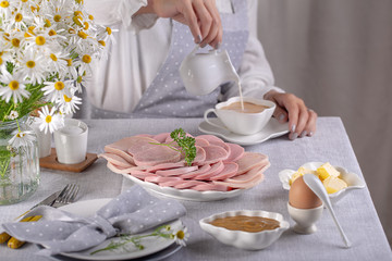 Obraz na płótnie Canvas ham and sausage sliced ​​for breakfast on the table