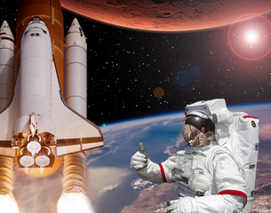 Rocket flies from earth to Mars. Astronaut shows the thumbs-up. Big sun.  The elements of this image furnished by NASA. © wowinside