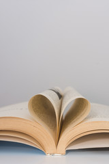 Book with its pages shaping as a heart