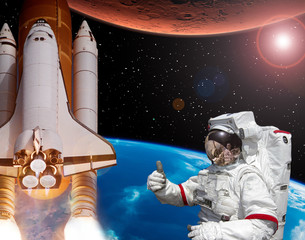Rocket flies from earth to Mars. Astronaut shows the thumbs-up. Big sun.  The elements of this...