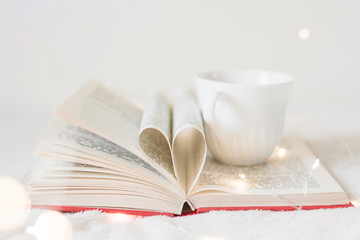 Book with its pages shaping as a heart
