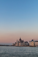 Obraz na płótnie Canvas The Hungarian Parliament Building on the Danube River in Budapest, Hungary at sunset.