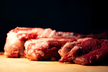 Raw ribs on the board. Close-up..