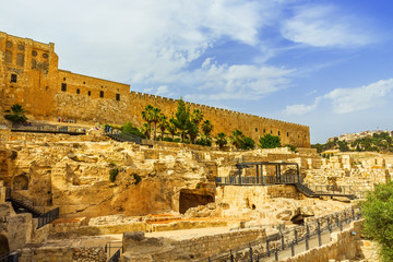 The fortress wall of ancient Jerusalem with the excavation of ancient buildings