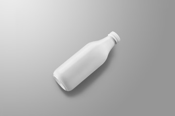 White plastic bottle with reflections and shadows  lies on a gray studio background.