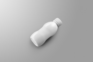  Small blank plastic bottle with reflections and shadows lies on a gray studio background.