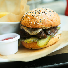 Beef burger with pickles and truffle sauce