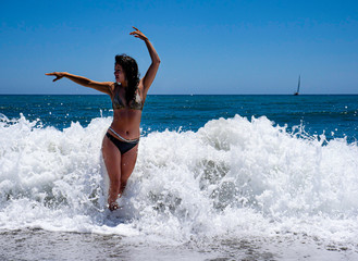 Woman in surf of waves