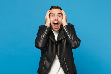 Young sad frustrated worried unshaven man in black jacket white t-shirt looking camera isolated on...