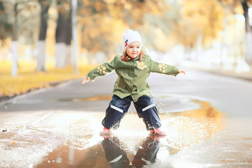 little girl on an autumn walk in the park