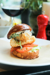 Fish burger with tomatoes and lettuce