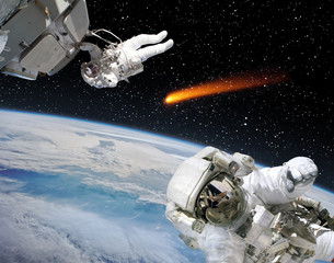 Astronauts and comet. The elements of this image furnished by NASA.