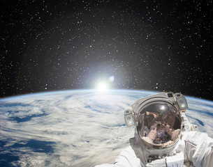 Astronaut makes selfie against sunrise. The elements of this image furnished by NASA.