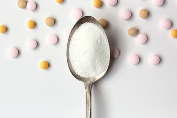 Fototapeta na wymiar Closeup of myo-inositol powder on a spoon. Myo-inositol is a commonly used supplement for treating PCOS symptoms.