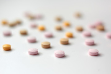 Closeup of colourful pills on white background. 
