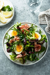 Fototapeta premium Green salad with eggs and smoked ham