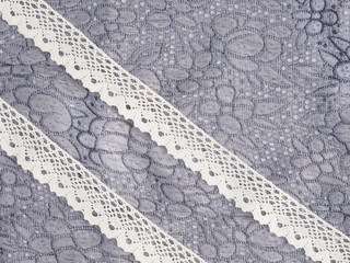 Lace on a background of gray fabric. Concept sewing still life