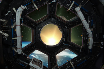 Fascinating sunrise on earth. Spaceship window view. Elements of this image furnished by NASA.
