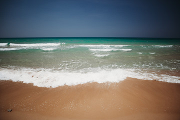 Mediterranean beach with turquoise water in sunny weather