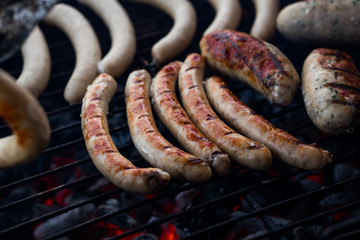 Cooking sausages on the barbecue grill. Grilled sausages. 