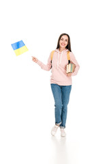 full length view of smiling student with backpack holding Ukrainian flag and books isolated on white