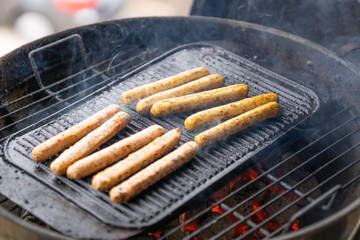 Cooking sausages on the barbecue grill. Grilled sausages