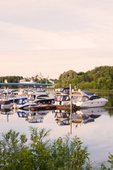 Fototapeta premium Yaroslavl. View of the Parking boats on the Kotorosl river and the Spaso-Preobrazhensky monastery. Summer evening before sunset