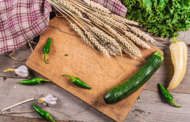 Zucchini. Fresh vegetables on a wooden board. Vegan food.