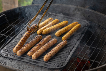 Cooking sausages on the barbecue grill. Grilled sausages