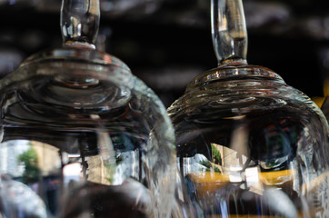 Fototapeta na wymiar Close-up of two clean empty glasses above the bar counter. Interior of pub, bar or restaurant