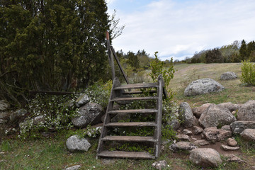 Old wooden stile crossing a broken dry stone wall