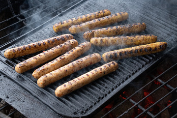 Cooking sausages on the barbecue grill. Grilled sausages