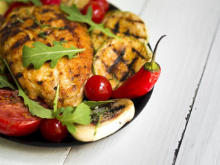 Grilled chicken breasts with vegetables