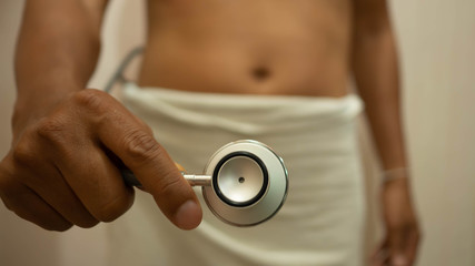 Man put a white towel holding Stethoscope look at the area of ​​sex. Concept Checking sexual...