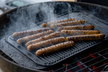 Cooking sausages on the barbecue grill. Grilled sausages