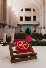 holy bible on table during a wedding ceremony nuptial mass. Religion concept. Catholic eucharist ornaments for the celebration of the Eucharist