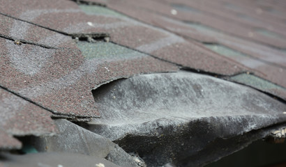 Damaged asphalt shingles house roof, damaged roof