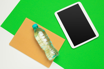sport, healthy lifestyle and objects concept - close up of tablet pc computer with water bottle