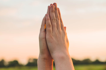 Hands folded in prayer concept for faith, spirituality and religion. Peace, hope, dreams concept