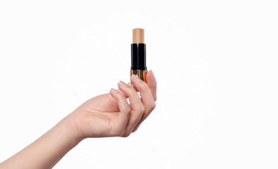Crop hand with beige lipstick
