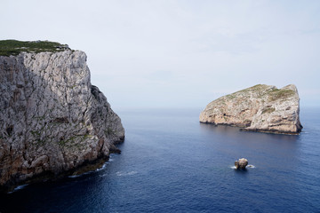 Fototapeta na wymiar Capo Caccia, Foradada Island. Imposing white limestone cliff, in Sardinia/Sardegna, Italy