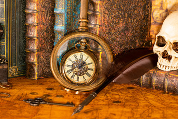 Antique clock on the background of a magnifying glass and books. Vintage style. 1565 old map of the year.