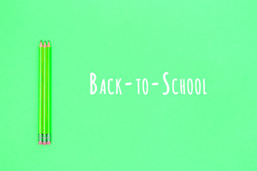Pencils on a neon green background. Back to school concept. Horizontal. Back to school wording