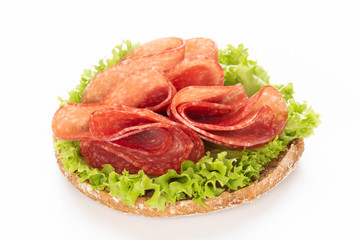 Sandwich with salami sausage on white background.