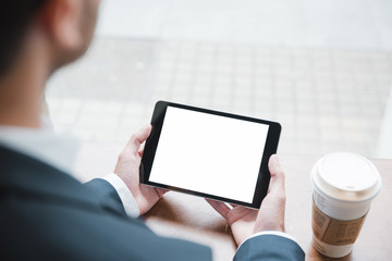 Close-up of a businessman looking at digital tablet with white screen display in cafï¿½