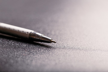 automatic silver plastic ballpoint pen with clipping path on black background. close up.